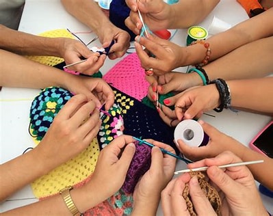 image of many hands crafting together