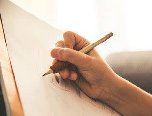 Image of a hand holding a pencil 